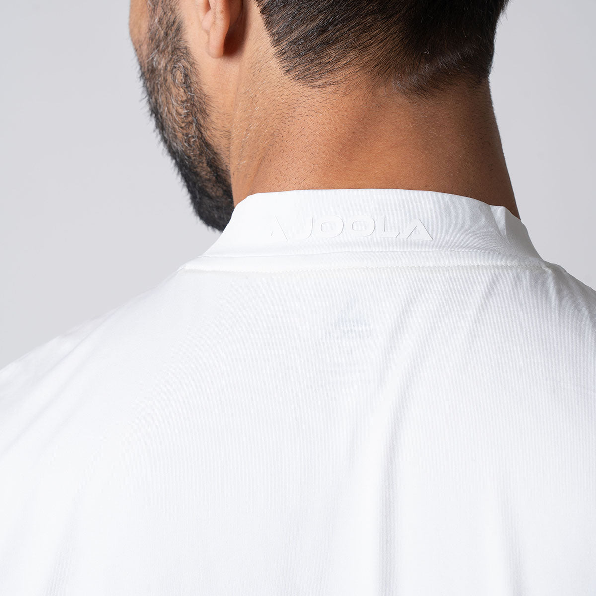 Image showing the JOOLA logo on the collar of a JOOLA men's court polo, white.