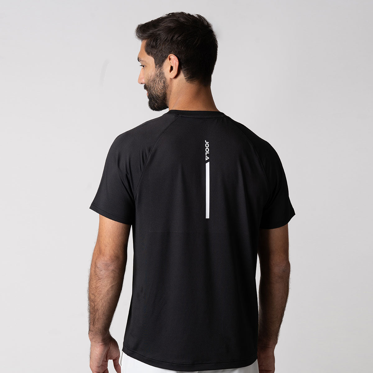 Image showing the back side of a JOOLA Men's Court Short Sleeve shirt, black with white JOOLA logo down the center.