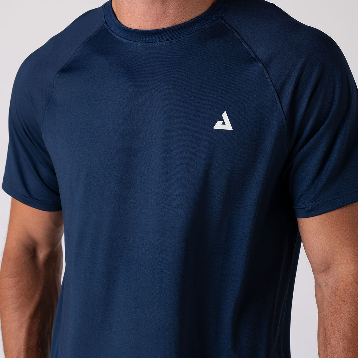Close up image of a male model who is wearing a JOOLA Men's Court Short Sleeve shirt, Navy.
