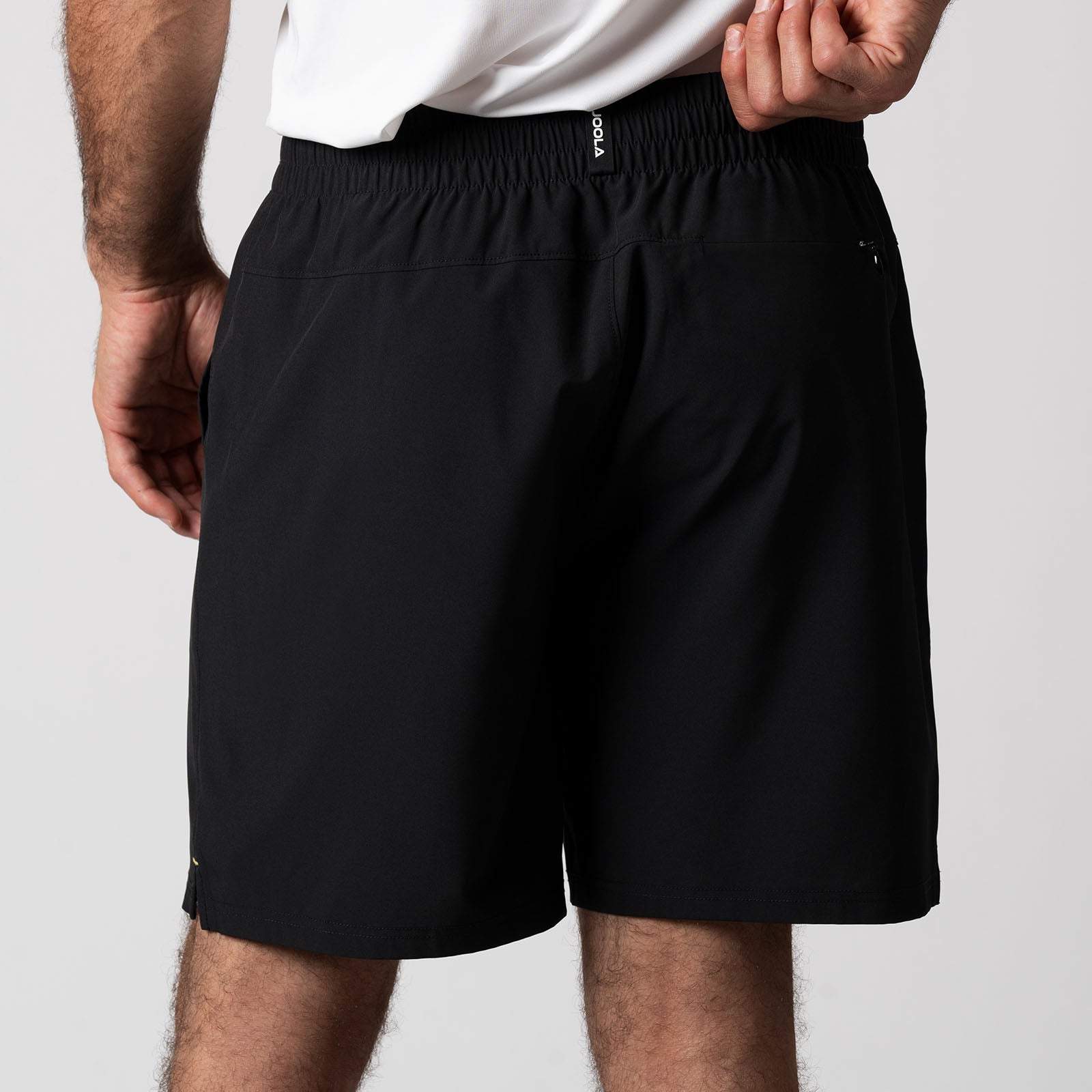 Close up image showing the back of a pair of JOOLA Men's Woven Shorts, 7 inch inseam, black.