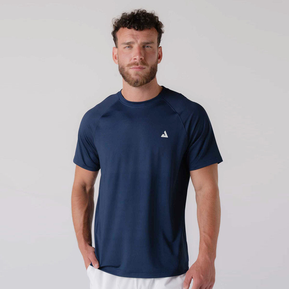 Image of a male model wearing a JOOLA men's court short sleeve shirt, navy.